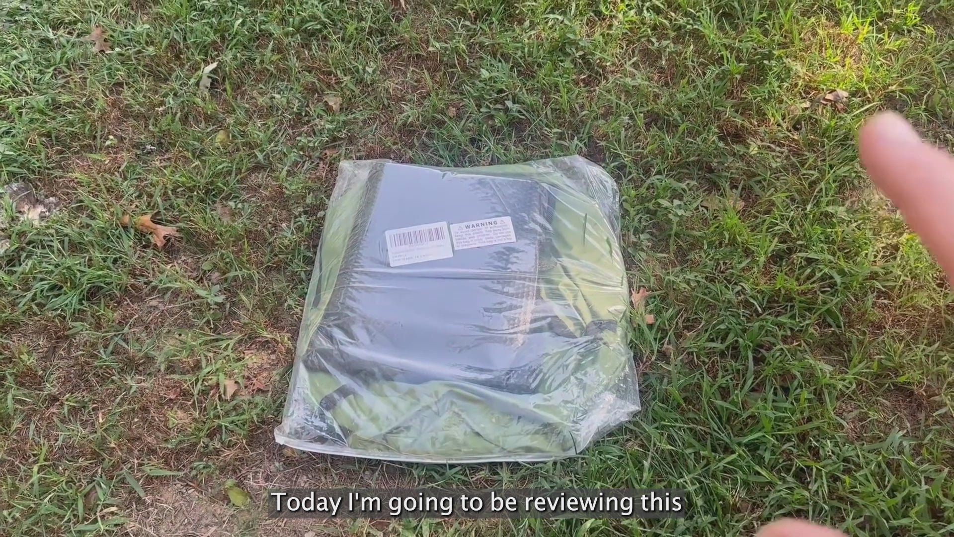 Load video: Wildloo portable camping toilet unboxing review video showing packaged privacy tent on grass